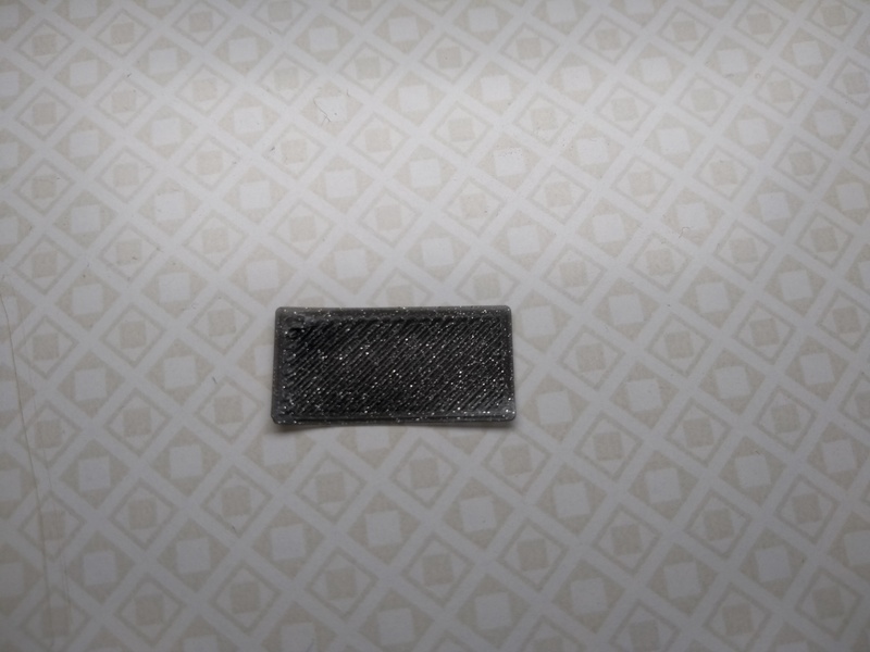 A rectangular one-layer calibration print. Neither gaps between extruded lines, nor ridges are visible.