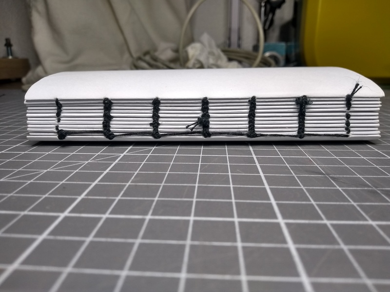 The text block, facing the spine, sewn.